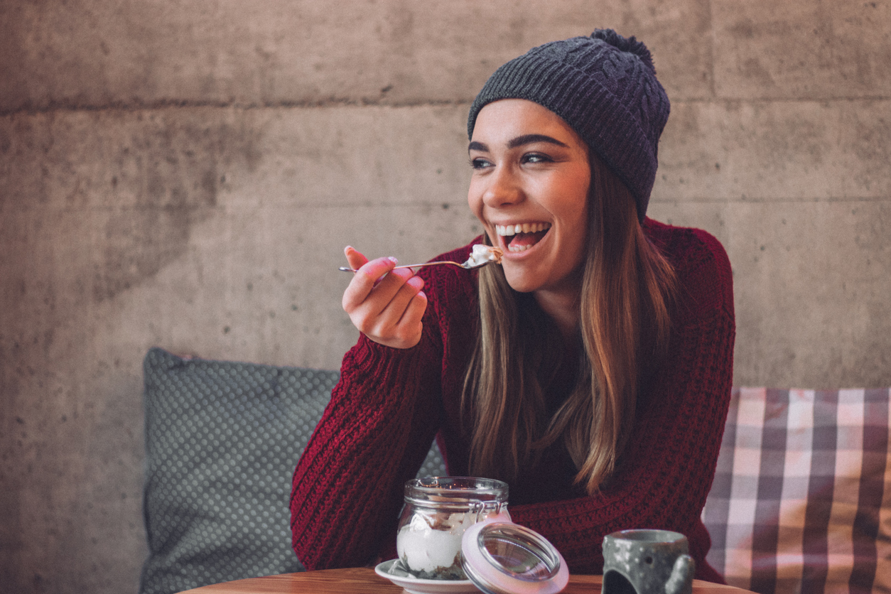 Happy woman eating healthy sweet snack